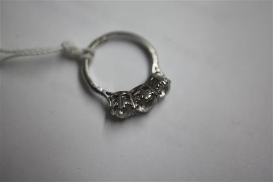 A mid 20th century white gold and three stone diamond ring, size closed, K.